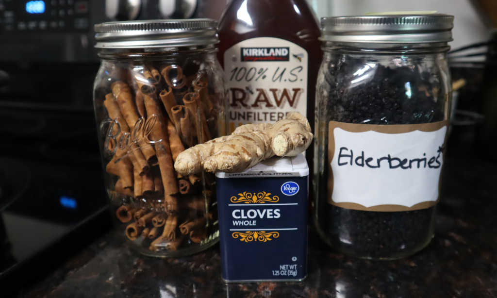 Ingredients shown: Elderberries, cinnamon, ginger, cloves, unfiltered raw honey.